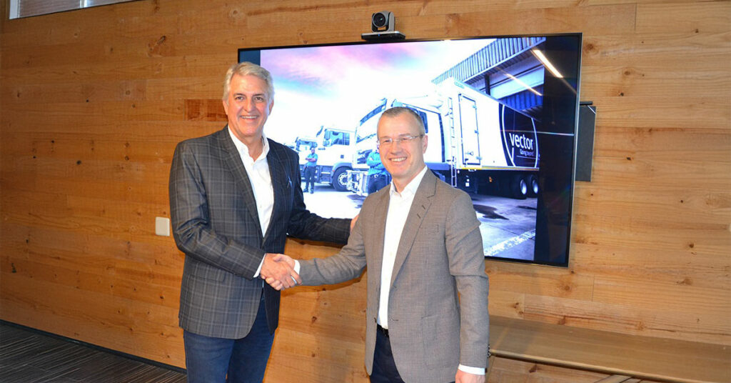 AP Moller acquires Vector Logistics showing two business men shaking hands